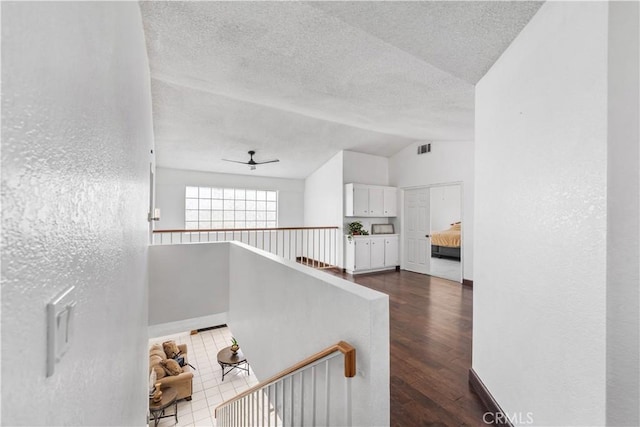 42851 Lemonwood Dr, Lancaster, CA 93536 - stairs with lofted ceiling, a ceiling fan, a textured ceiling, wood finished floors, and a textured wall