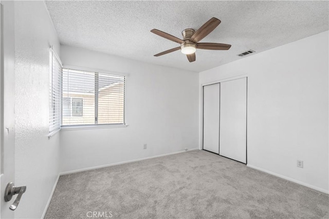 42851 Lemonwood Dr, Lancaster, CA 93536 - unfurnished bedroom with carpet flooring, a closet, a textured ceiling, and ceiling fan