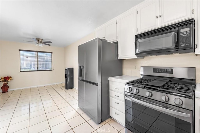 42851 Lemonwood Dr, Lancaster, CA 93536 - kitchen featuring appliances with stainless steel finishes, ceiling fan, white cabinetry, tile counters, and light tile patterned flooring