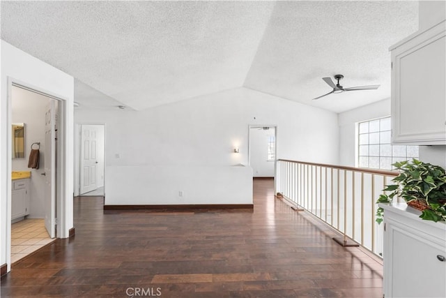 42851 Lemonwood Dr, Lancaster, CA 93536 - spare room featuring ceiling fan, hardwood / wood-style flooring, lofted ceiling, and a textured ceiling