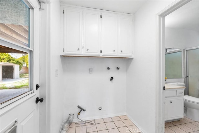42851 Lemonwood Dr, Lancaster, CA 93536 - washroom with gas dryer hookup, cabinet space, light tile patterned floors, and hookup for a washing machine