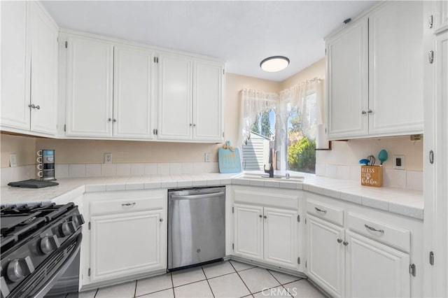 42851 Lemonwood Dr, Lancaster, CA 93536 - kitchen featuring dishwasher, black gas range, and white cabinetry
