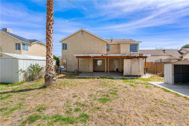 42851 Lemonwood Dr, Lancaster, CA 93536 - back of house with a shed, a patio area, and stucco siding