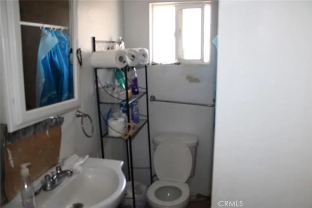 241 Hull Ave, Madera, CA 93638 - bathroom with a sink, toilet, and a shower with shower curtain