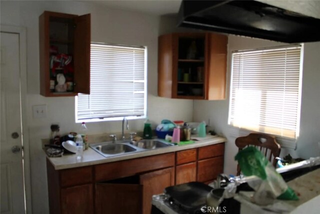 241 Hull Ave, Madera, CA 93638 - kitchen featuring a sink, open shelves, brown cabinets, and light countertops