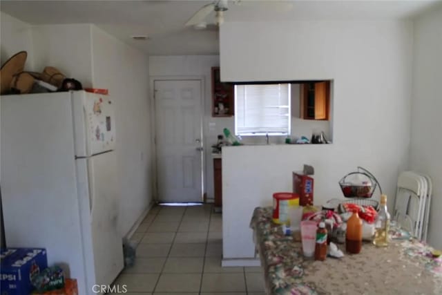 241 Hull Ave, Madera, CA 93638 - kitchen featuring light tile patterned floors, light countertops, freestanding refrigerator, and a ceiling fan
