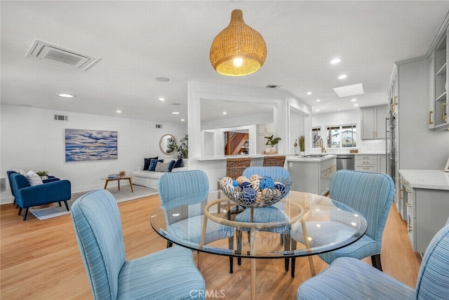 dining room with recessed lighting, visible vents, and light wood-style flooring
