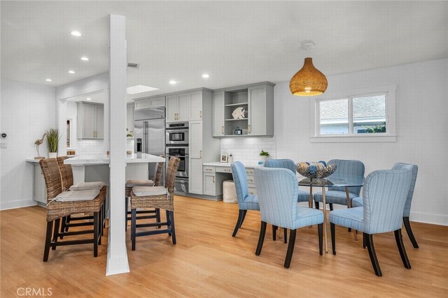 dining space with visible vents, recessed lighting, baseboards, and light wood-style floors