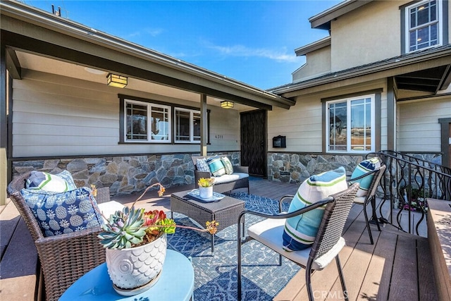 wooden deck with an outdoor living space