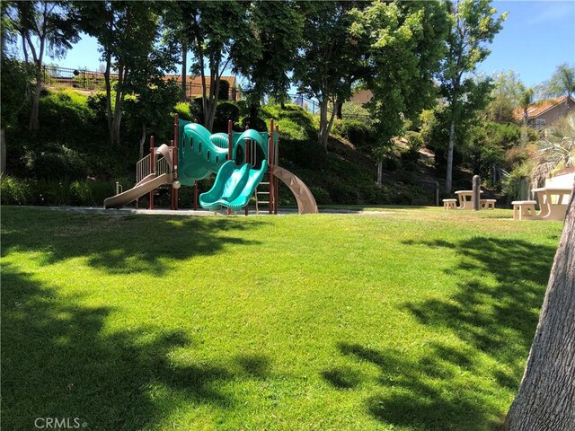 communal playground featuring a lawn