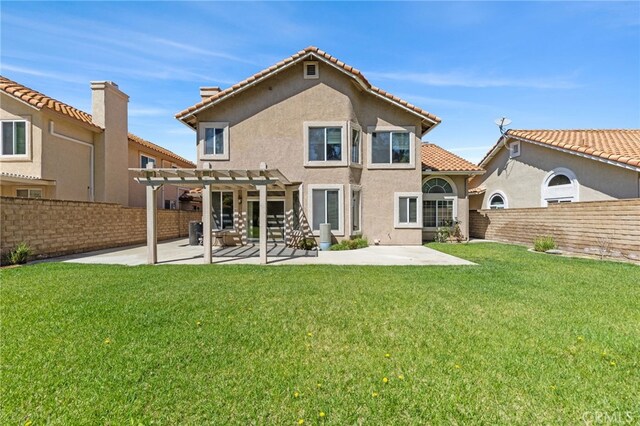 rear view of property with a pergola, a patio, a fenced backyard, and stucco siding