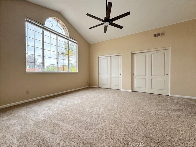 unfurnished bedroom with carpet floors, baseboards, multiple closets, and visible vents