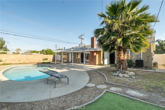 view of pool featuring a patio, a fenced backyard, a fenced in pool, and central AC unit