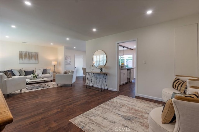living area featuring recessed lighting, baseboards, and dark wood finished floors