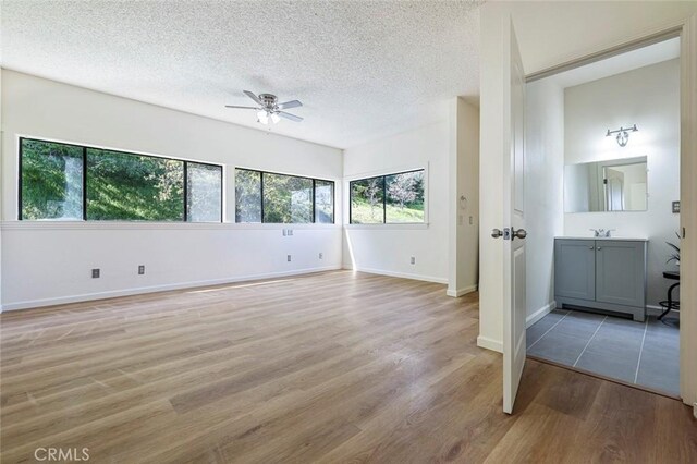 28951 Spring Valley Rd, Tollhouse, CA 93667 - interior space featuring a textured ceiling, light wood-style flooring, baseboards, and ceiling fan