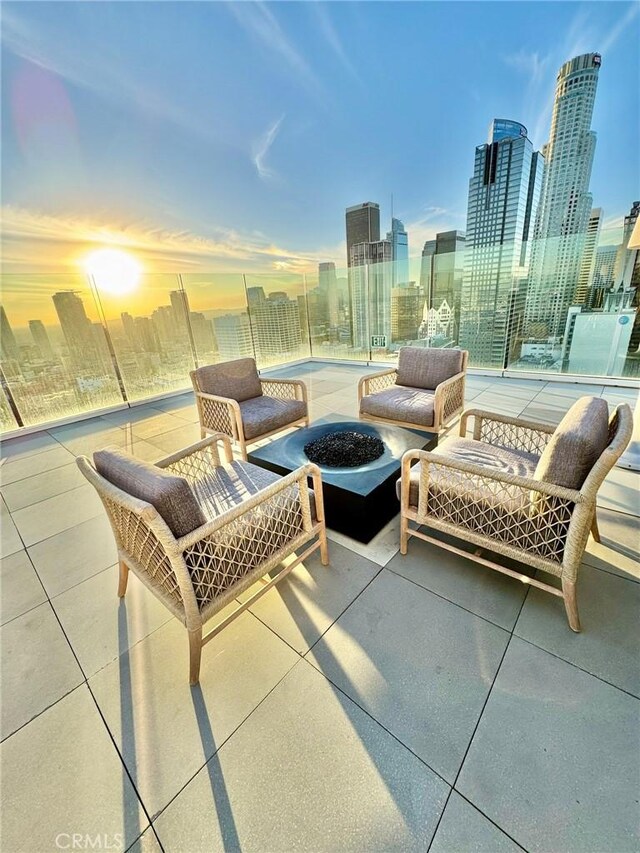 400 S Broadway Unit 1011, Los Angeles, CA 90013 - patio terrace at dusk featuring a skyline view, a patio area, and an outdoor fire pit