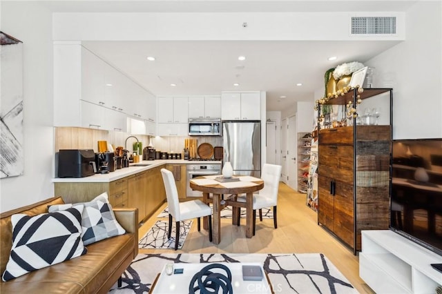 400 S Broadway Unit 1011, Los Angeles, CA 90013 - dining space with light wood-style flooring and recessed lighting