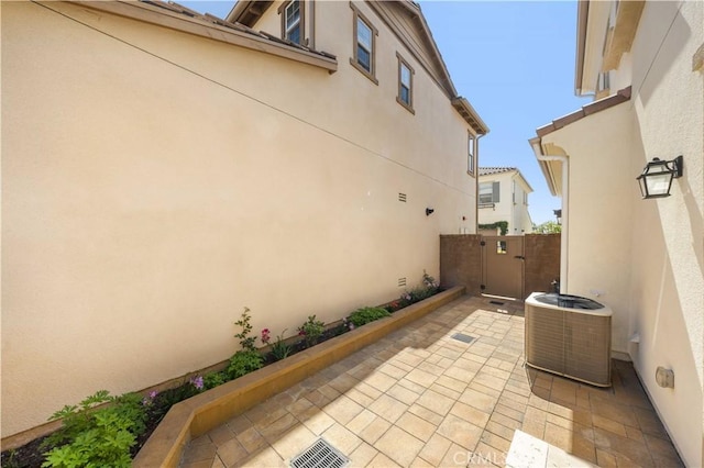 view of patio / terrace with fence and central AC