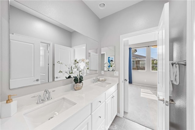 bathroom with tile patterned flooring, double vanity, and a sink