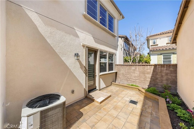view of patio / terrace featuring cooling unit and fence