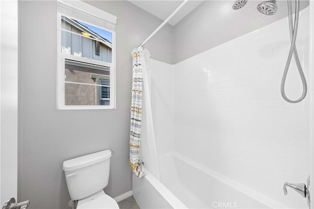 bathroom featuring toilet and shower / bath combo