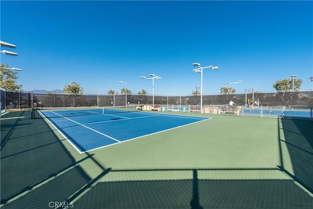 view of sport court featuring fence