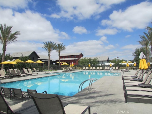 community pool featuring a patio and fence