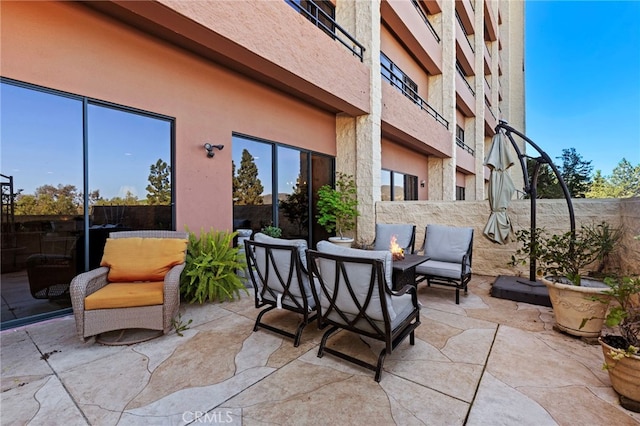 view of patio featuring outdoor lounge area and fence
