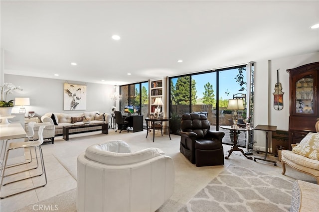 living area featuring floor to ceiling windows, recessed lighting, and light colored carpet