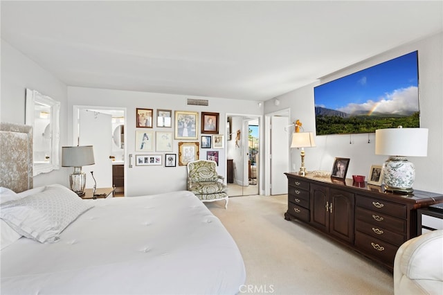 bedroom featuring visible vents and light colored carpet