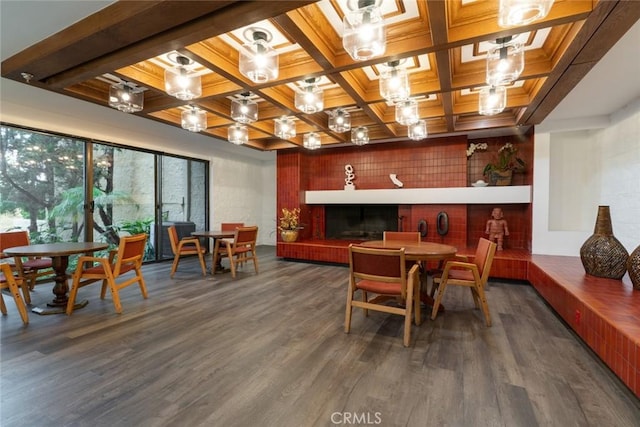 dining area with coffered ceiling, wood finished floors, and beam ceiling