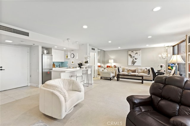 living area with an inviting chandelier, recessed lighting, light carpet, and visible vents