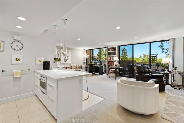 kitchen with open floor plan, light countertops, recessed lighting, and a peninsula