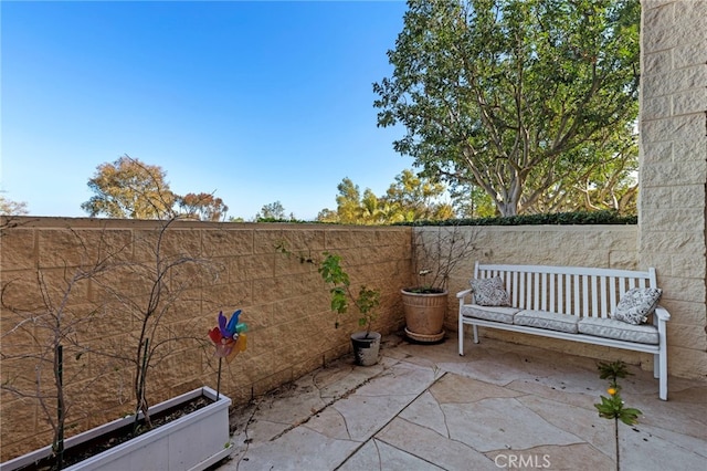 view of patio / terrace featuring fence