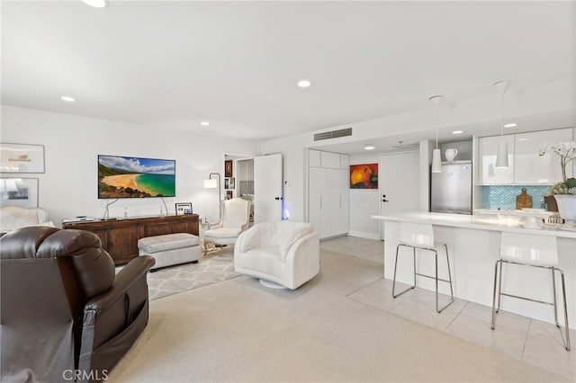 living room featuring light tile patterned flooring, light carpet, recessed lighting, and visible vents