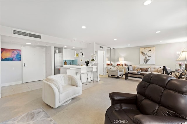 living room featuring light tile patterned floors, recessed lighting, light colored carpet, and visible vents