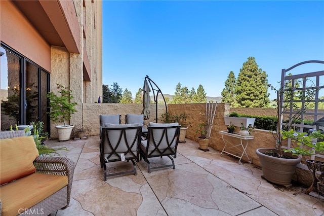 view of patio / terrace featuring fence and outdoor dining space