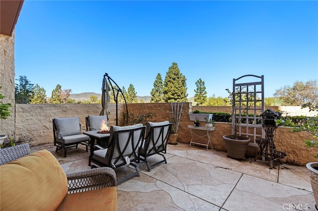 view of patio featuring an outdoor fire pit and a fenced backyard