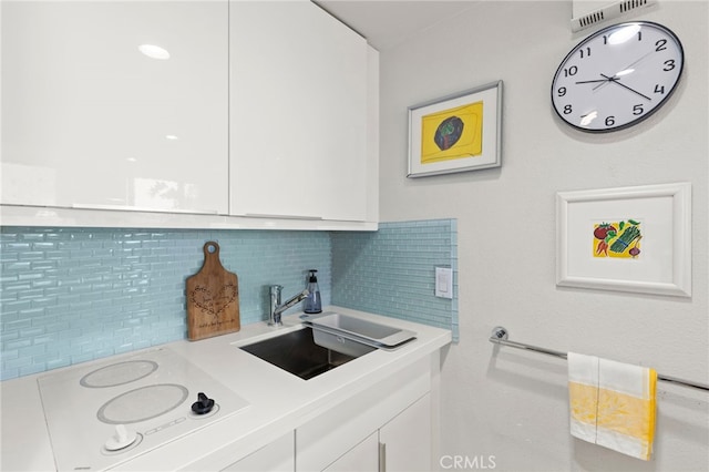 laundry room featuring a sink and visible vents