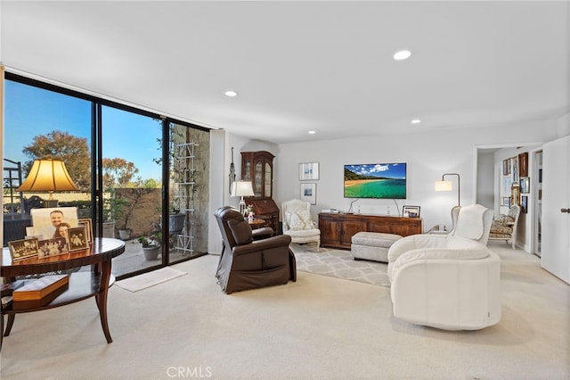 living area featuring carpet flooring, expansive windows, and recessed lighting