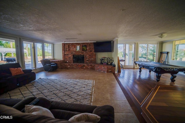 600 Monte Vista Dr, Santa Paula, CA 93060 - living area featuring a fireplace, a textured ceiling, billiards, and wood finished floors