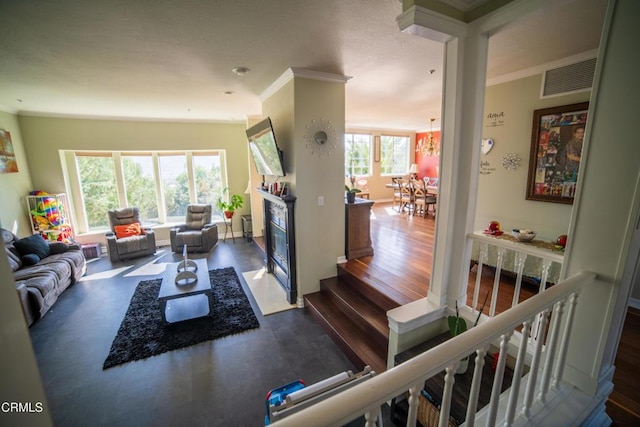 600 Monte Vista Dr, Santa Paula, CA 93060 - living area featuring visible vents, a fireplace with flush hearth, wood finished floors, crown molding, and baseboards