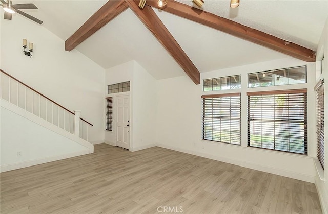 712 E Magill Ave, Fresno, CA 93710 - unfurnished living room with beam ceiling, stairs, light wood-style floors, ceiling fan, and high vaulted ceiling