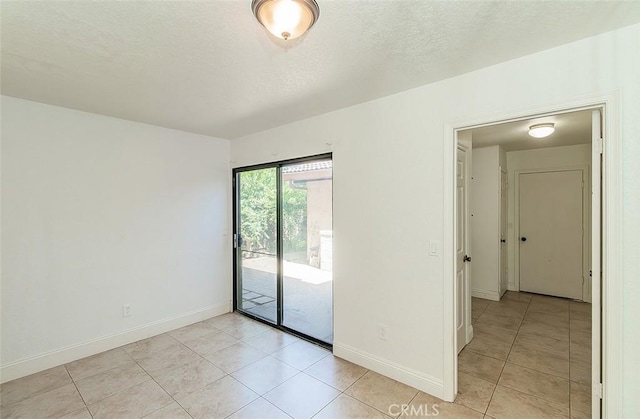 712 E Magill Ave, Fresno, CA 93710 - unfurnished room featuring light tile patterned floors and a textured ceiling