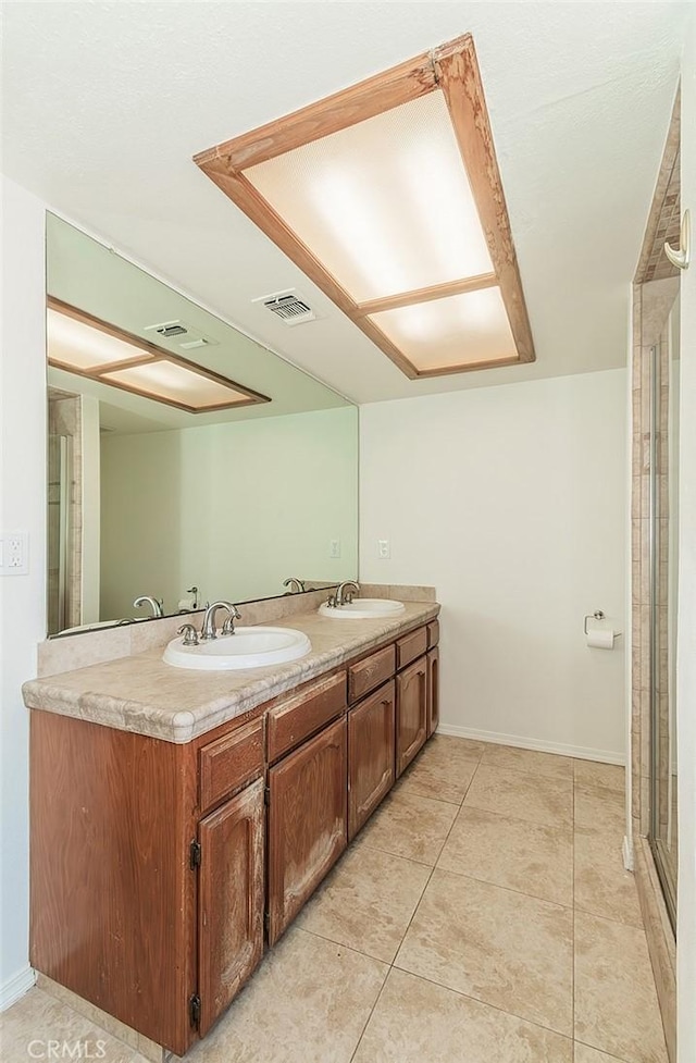 712 E Magill Ave, Fresno, CA 93710 - bathroom featuring double vanity and tile patterned floors