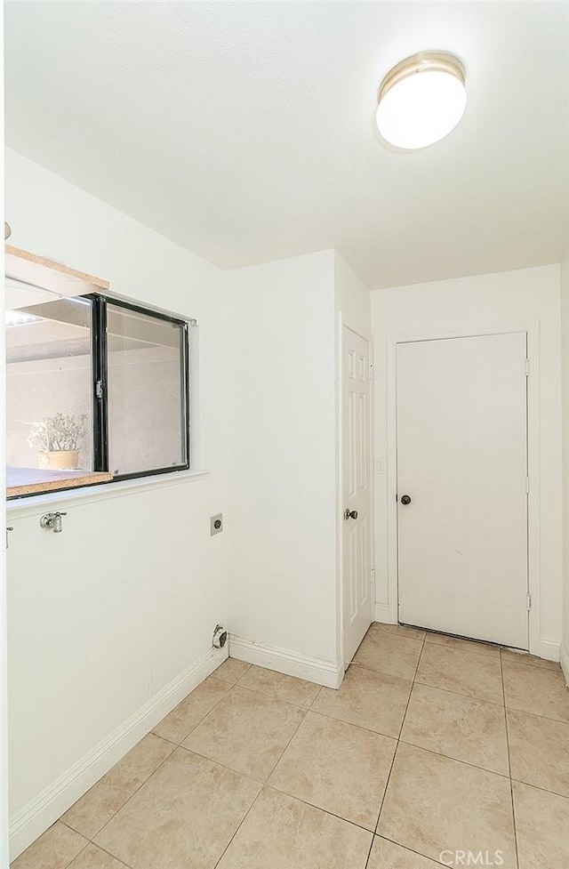 712 E Magill Ave, Fresno, CA 93710 - washroom featuring electric dryer hookup and light tile patterned flooring