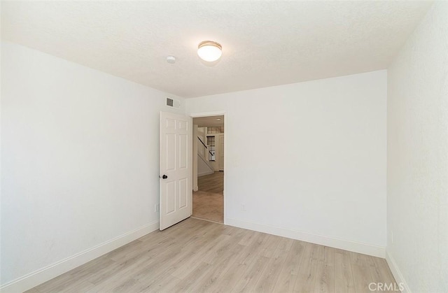 712 E Magill Ave, Fresno, CA 93710 - empty room with light wood-style floors and baseboards