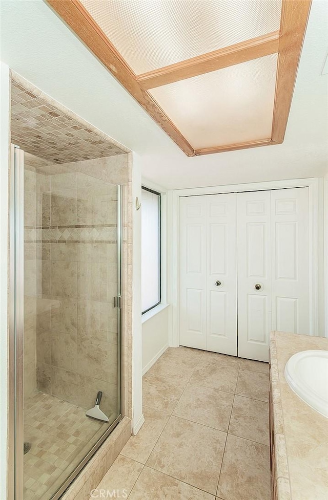 712 E Magill Ave, Fresno, CA 93710 - bathroom featuring a stall shower, tile patterned floors, and a relaxing tiled tub