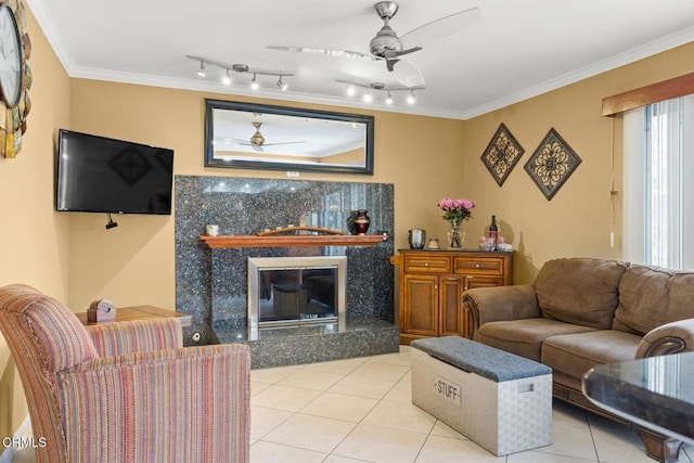 tiled living area with a premium fireplace, a ceiling fan, and crown molding