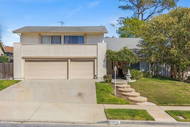 view of front of property featuring a front lawn, fence, stucco siding, a garage, and driveway